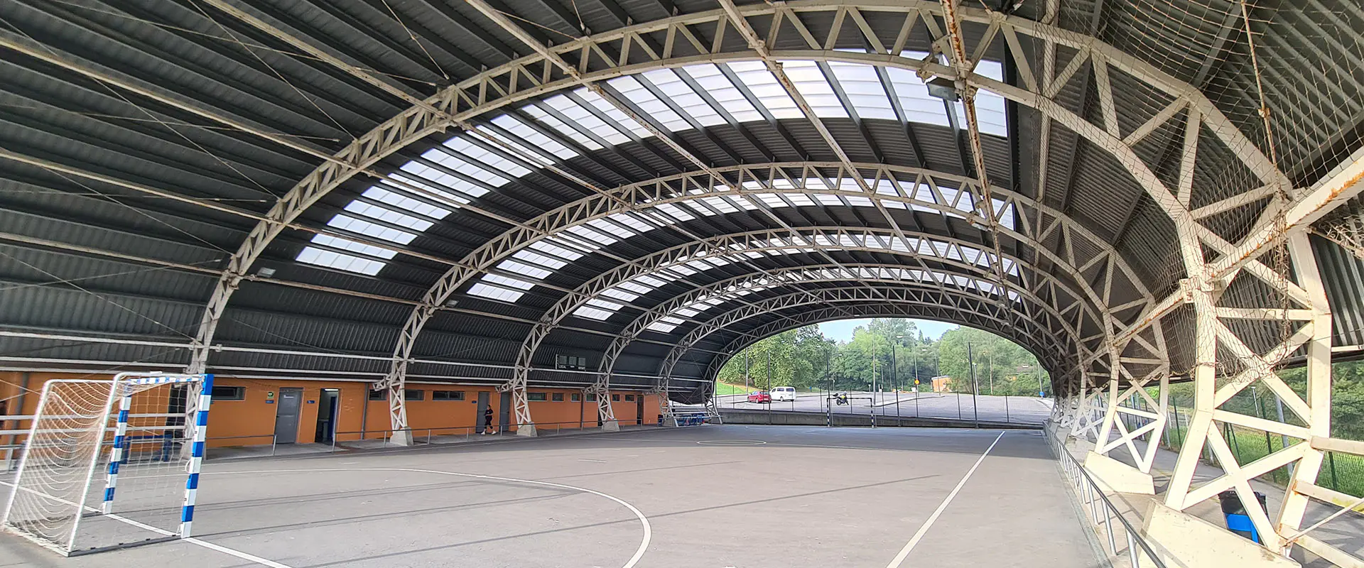 Panorámica de la pista polideportiva, con su cubierta metálica y unas porterías de fútbol 